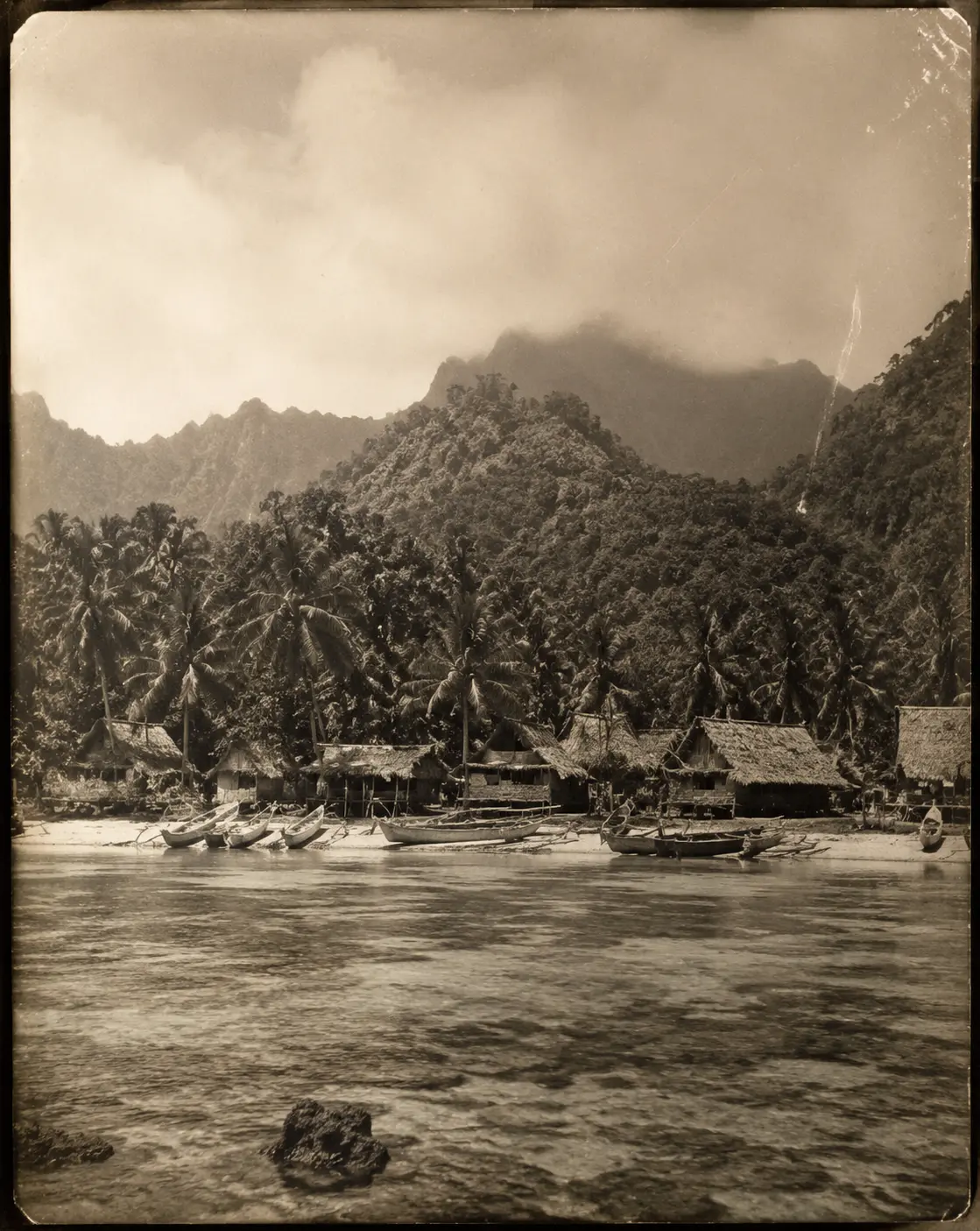 Village Beyond the Reef: A recovered old-film view of structures hidden beneath the canopy.